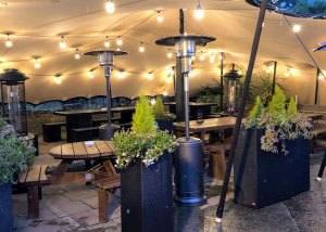 a room filled with furniture and vase of flowers on a table