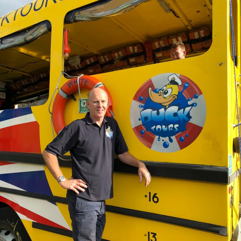 a person standing in front of a school bus
