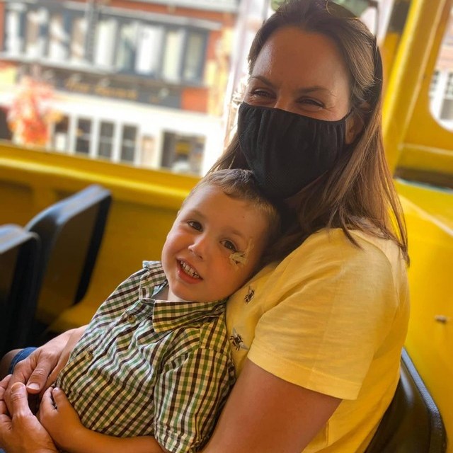 a woman sitting in a chair talking on a cell phone