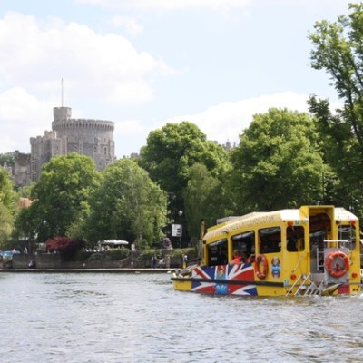 a passenger bus that is driving down the river