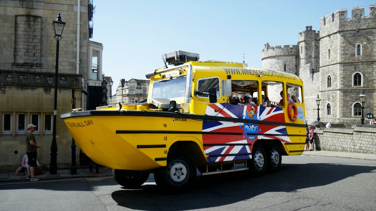 Duck-HenryVII-people a truck is parked in front of a building