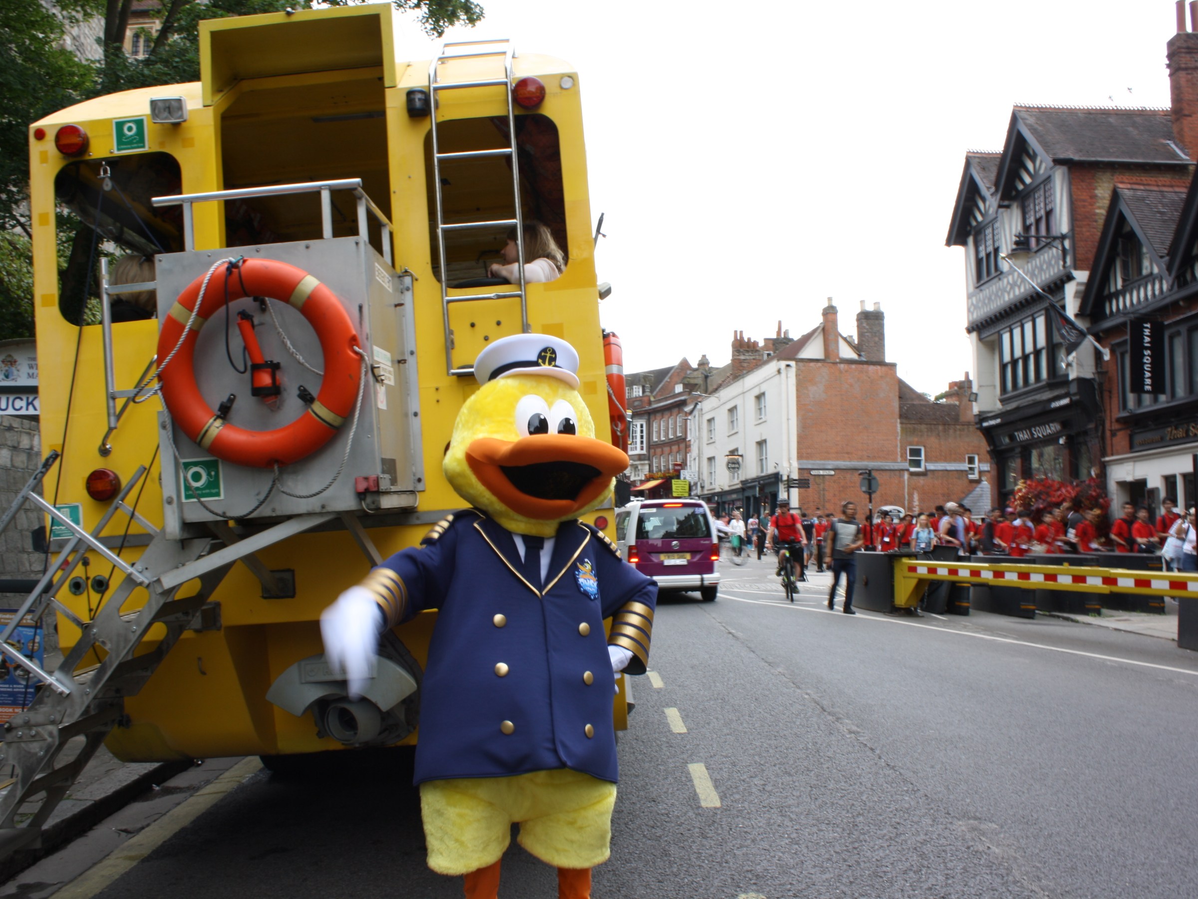 a yellow bus is parked on the side of a road
