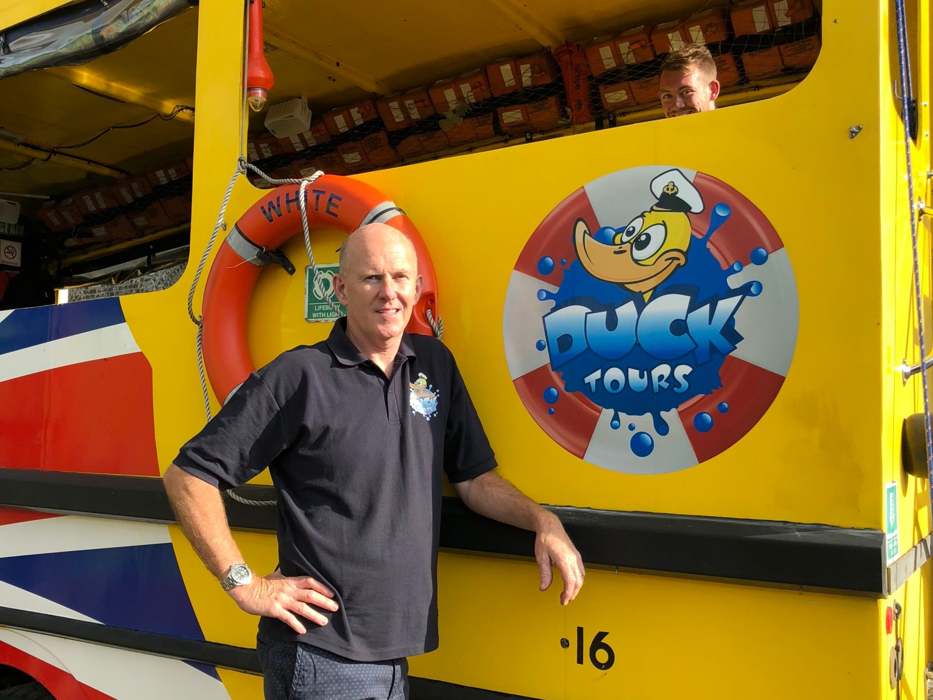 a person standing in front of a school bus