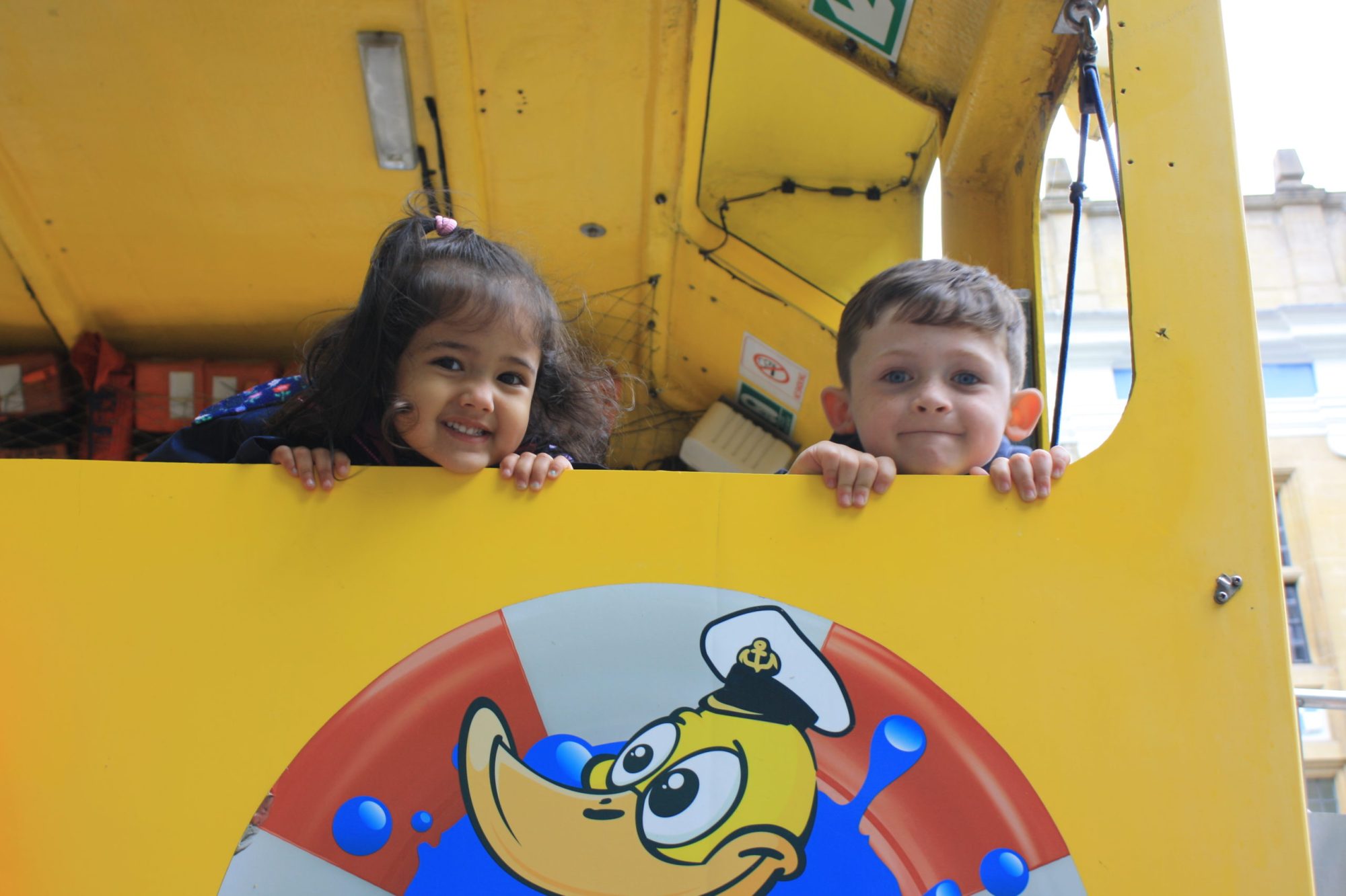 Copy of Two kids pocking heads over