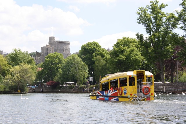 a passenger bus that is driving down the river